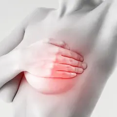 Mano che copre il seno con un'area rossa che indica bruciore e ansia.