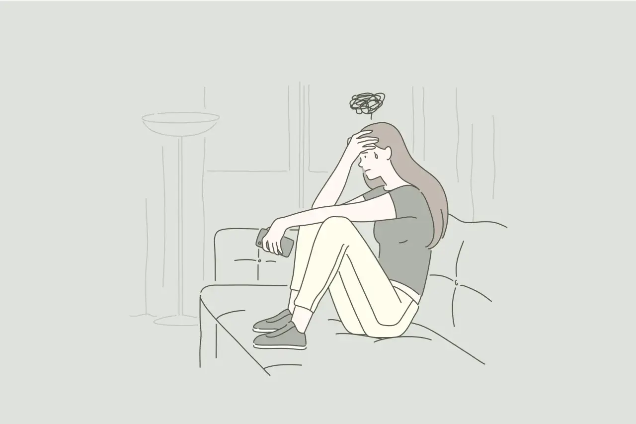 Ragazza seduta sul divano, con la mano sulla fronte e un groviglio di pensieri sopra la testa. Si sente persa, proprio come quando sto a casa sto male.