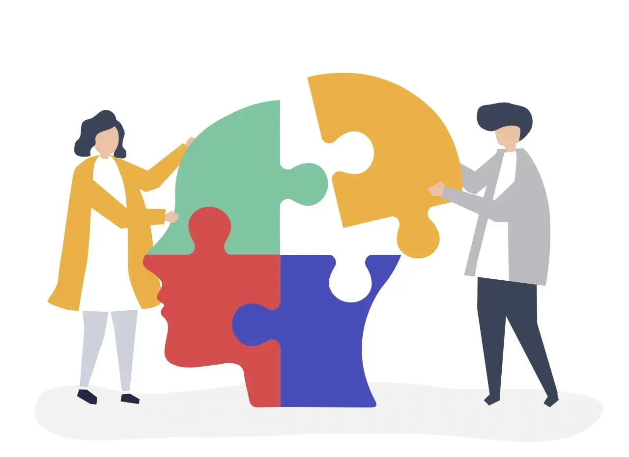 Due persone compongono un puzzle a forma di testa, simbolo della psicoterapia sistemico relazionale.